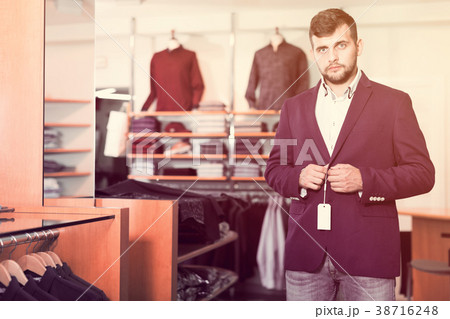 male client choosing classic jacket male client choosing classic jacket 38716248