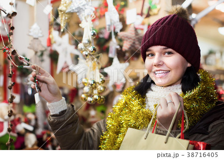Teenage girl in coat posing at Christmas market Teenage girl in coat posing at Christmas market 38716405