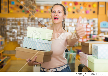Young female showing multi colored container Young female showing multi colored container 38716550