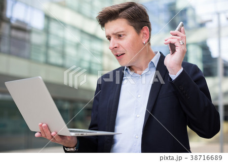 Cheerful businessman talking about work on the mobile phone Cheerful businessman talking about work on the mobile phone 38716689