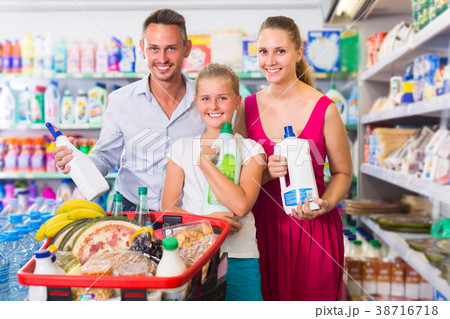 Family with child are selecting detergents 38716718
