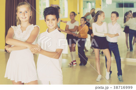Group of smiling children dancing salsa in school Group of smiling children dancing salsa in school 38716999