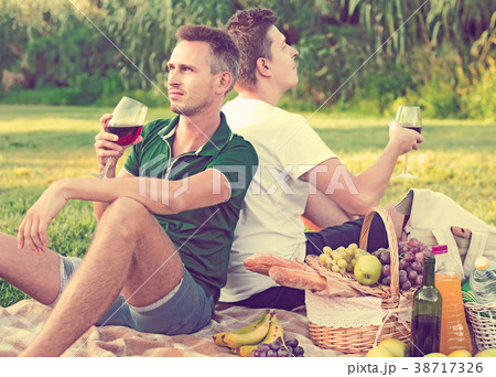 adult man with a friend enjoying picnic adult man with a friend enjoying picnic 38717326