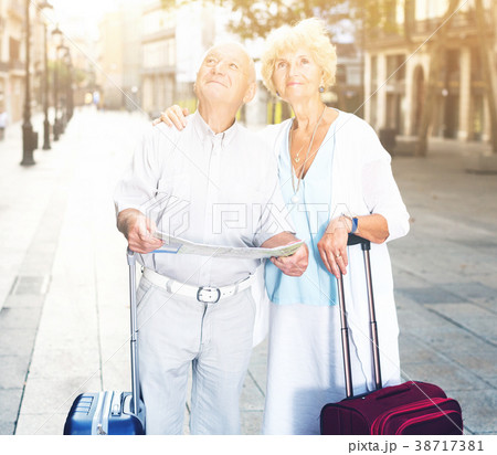 travellers with suitcases visiting sights of European city travellers with suitcases visiting sights of European city 38717381