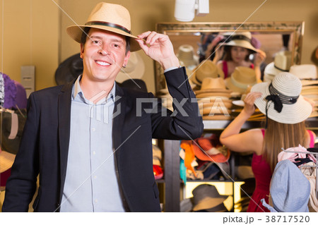 portrait of guy try on bucket hat at store 38717520