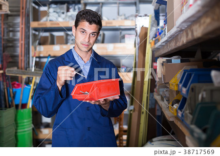 foreman is checking small details in boxes 38717569