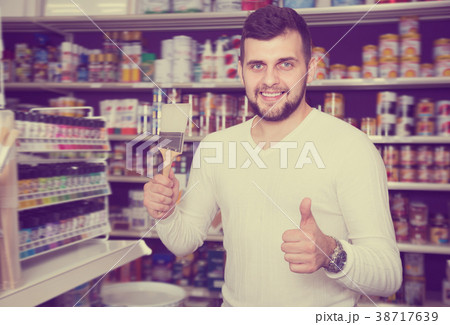 Glad man choosing new brush for decoration Glad man choosing new brush for decoration 38717639