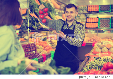 Male seller assisting in buying 38718327
