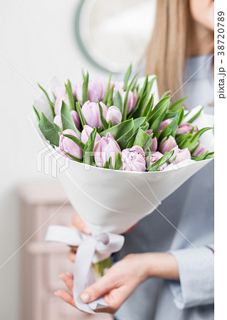 Sunny spring morning. Young happy woman holding a Sunny spring morning. Young happy woman holding a 38720789