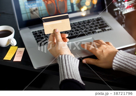 Woman holding gold credit card fir online shopping Woman holding gold credit card fir online shopping 38721796