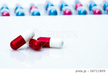 Red-white antibiotic capsule pills on pills pack 38721809