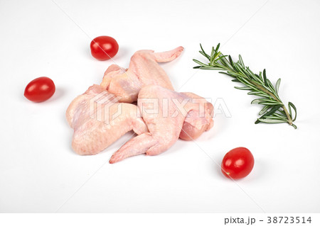 Raw chicken wings, tomatoes and rosemary isolated 38723514