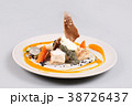 chicken breast with vegetables on a white plate. 38726437