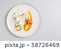 chicken breast with vegetables on a white plate. 38726469
