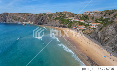 Aerial. Tourists surfers on the beach of Arrifana. Aerial. Tourists surfers on the beach of Arrifana. 38728736