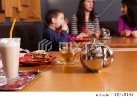 Women and children having a drink Women and children having a drink 38729142