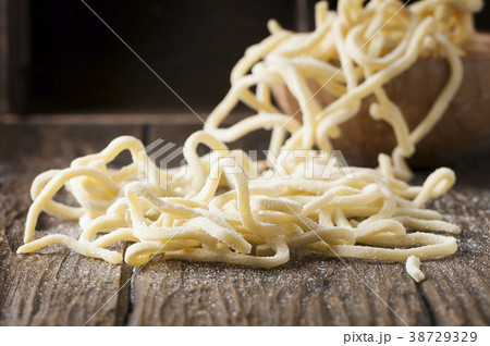Italian uncooked pasta on the wooden table Italian uncooked pasta on the wooden table 38729329