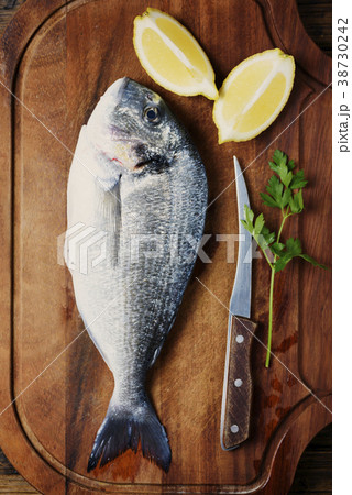 Healthy fresh raw fish on the wooden board Healthy fresh raw fish on the wooden board 38730242