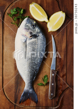 Healthy fresh raw fish on the wooden board Healthy fresh raw fish on the wooden board 38730243
