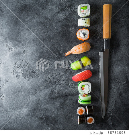 Food concept with sushi, rolls and knife on dark 38731093