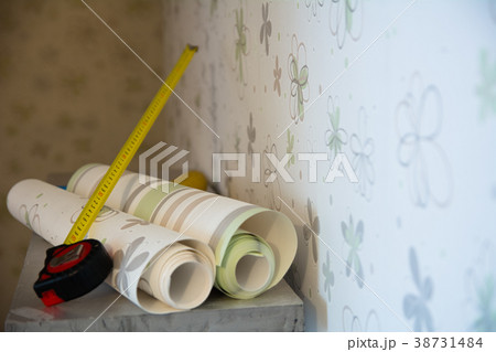 Two rolls of wallpaper and a measuring tape Two rolls of wallpaper and a measuring tape 38731484