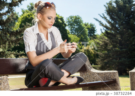 Young woman texting on a cell phone 38732284