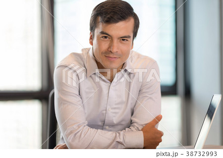 Smart and handsome businessman in workplace. Smart and handsome businessman in workplace. 38732993