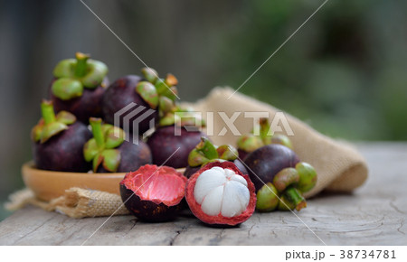 Mangosteen fruit on a wooden table. Mangosteen fruit on a wooden table. 38734781