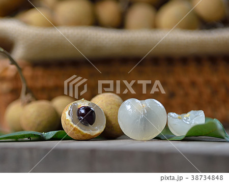 Fresh longan isolated on wooden background Fresh longan isolated on wooden background 38734848