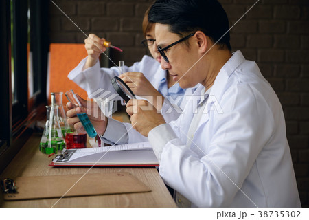 male scientist inspect chemical liquid male scientist inspect chemical liquid 38735302