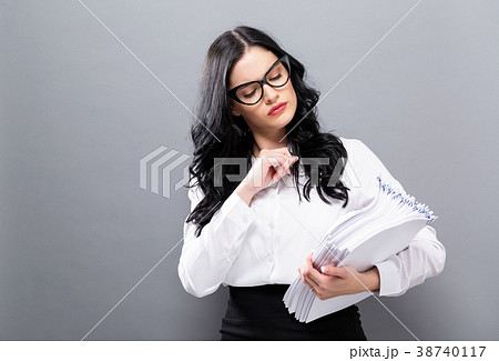 Office woman with a stack of documents Office woman with a stack of documents 38740117