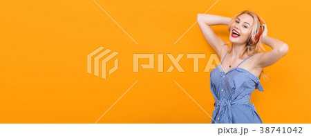 Blonde girl in blue striped blouse with headphones Blonde girl in blue striped blouse with headphones 38741042