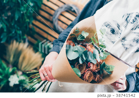 Florist at work on arragment flower bouquet 38741542