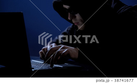 Criminal secretly using laptop, unauthorized Criminal secretly using laptop, unauthorized 38741677