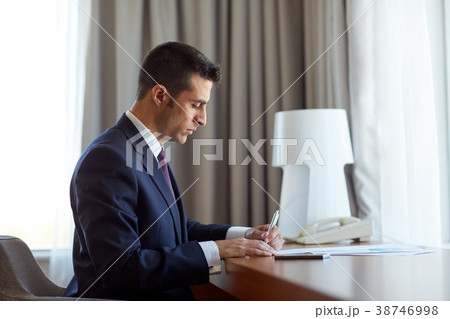 businessman with papers working at hotel room 38746998