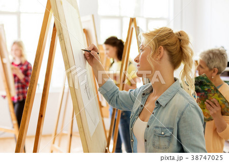 woman with easel drawing at art school studio 38747025