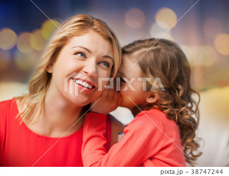 happy mother and girl whispering into ear 38747244