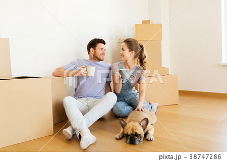 happy couple with boxes and dog moving to new home happy couple with boxes and dog moving to new home 38747286