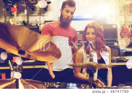 couple of musicians with drum kit at music store couple of musicians with drum kit at music store 38747790