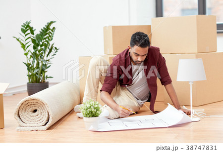 man with blueprint and boxes moving to new home man with blueprint and boxes moving to new home 38747831