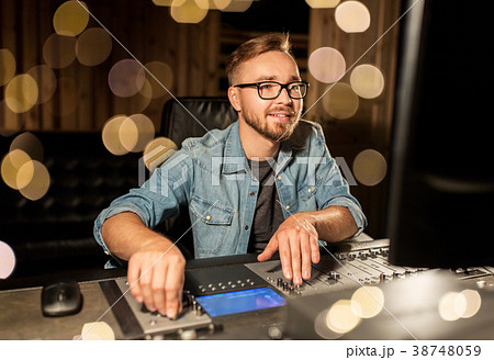 man at mixing console in music recording studio 38748059