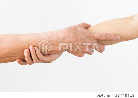 close up of senior and young woman holding hands close up of senior and young woman holding hands 38748418