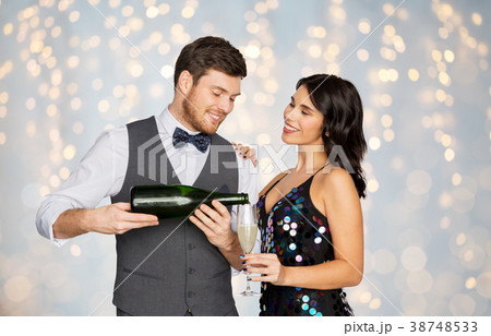 happy couple with champagne and glass at party happy couple with champagne and glass at party 38748533