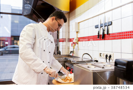 chef making shawarma wrap with meat at kebab shop chef making shawarma wrap with meat at kebab shop 38748534