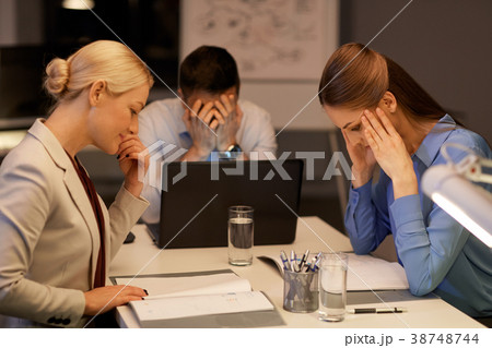 business team with laptop working late at office 38748744