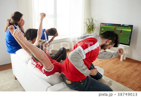 football fans watching soccer game on tv at home 38749013