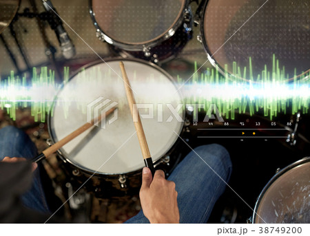 male musician playing drum kit at concert 38749200
