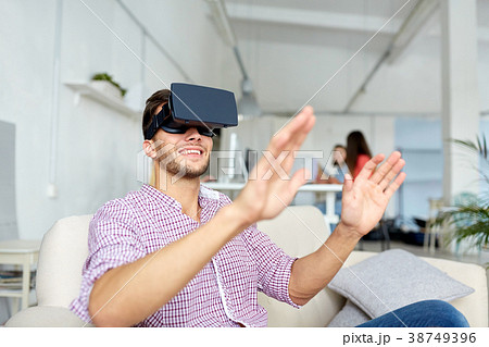 happy man with virtual reality headset at office happy man with virtual reality headset at office 38749396