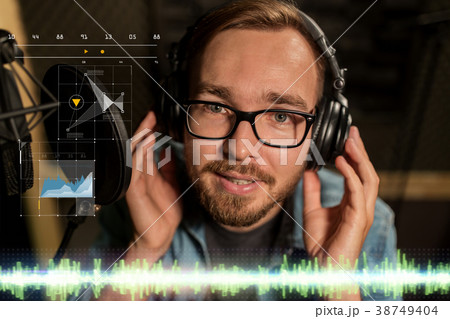 man with headphones singing at recording studio man with headphones singing at recording studio 38749404
