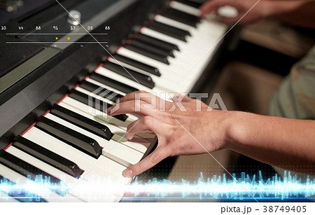 hands playing piano at sound recording studio 38749405